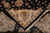 Back of the rug folded to show tight knotting, cotton foundation and ivory hand-tied fringe