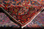 Back of the rug folded over the front, showing knot density and cotton foundation