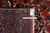 Tape measure and hand woven authenticity tag laid across the back of this Persian rug