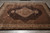 8'2" x 10'1" hand-knotted wool and silk area rug displayed flat on grey tile floor