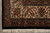 Squared corner of the ivory main border framed by black outer band and fringe