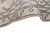 Curled edge showing pink selvage wrap, shallow pile depth and brown floral border drawing
