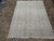 Full 6'6" x 9'10" Tabriz rug photographed on tile floor, showing pastel field and fringed ends