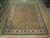 9 by 11'9 Ziglar rug shown flat on showroom floor with full olive green field