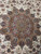 Close detail of the 10' x 13' Persian Tabriz rug medallion and floral scrollwork
