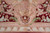 Detail of the burgundy field meeting the blush diamond lattice frame and leaf-drop guard band