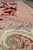 Border close-up highlighting cream scrollwork, soft peach lattice and hand-carved outlines in thick wool pile