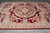 9 by 12 French design rug angled on tile, showing carved lattice border and acanthus corners