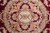 Central medallion detail with sage green rosette, gold cartouches and pastel rose garlands on burgundy