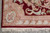 Corner detail with sage shield motif, striped guard band and clean ivory cotton fringe