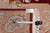 Inventory tag F-4161 and tape measure confirming the 9x12 size against the rug fringe