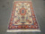 5 x 8 Persian Tabriz wool and silk rug laid flat on grey warehouse floor