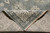 Folded corner revealing ivory cotton foundation and dense hand-knotted back of this Indian Oriental rug