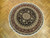 6' x 6'3" round hand-knotted Oriental rug displayed on parquet wood floor indoors