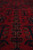 Detail of vertical floral column motifs in madder red with copper and ivory outlines