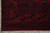 Corner detail of main border with navy cartouche shapes, rust palmettes and clean selvedge
