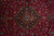 Detail of navy lobed medallion with camel rosette core and dense red-ground floral vinework