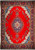 Red Persian Sarouk rug with navy medallion, ivory spandrels and floral borders photographed flat overhead