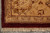 Corner detail of gold border, guard stripe, burgundy outer band and hand-tied cotton fringe