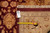 Reverse of the rug with inventory tag and tape measure confirming size and hand-knotted construction