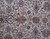 Close-up of ivory field with pink rosettes, navy palmettes and curling green vines in wool