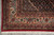 Corner view of ivory main border with rosettes, palmettes and clean cream cotton fringe
