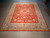 9'1" x 12' hand-knotted Pakistani Ziegler rug laid flat showing the full coral and blue layout