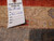 Inventory tag reading Genuine Hand Woven Oriental Rug number 15128 pinned to the rug back