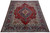 8'1" x 11'3" Persian Tabriz rug photographed at an angle, red field with navy and ivory borders