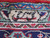 Woven signature cartouche in the ivory border of this signed Persian Tabriz wool rug