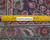 Reverse side with ruler against tight hand-knotted wool weave confirming authentic Persian construction