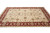 Living room size Oriental rug shot low, burgundy border framing a softly shaded ivory floral field