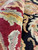 Macro shot of red, gold and sage pile depth on this new hand-knotted rug