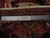 Back of the 8'4" x 11'8" Heriz rug with ruler and Authentic Handmade label