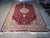 6'6 x 9'10 Turkish bamboo silk rug laid flat showing wine field and ivory fringe
