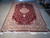 6'6 x 9'10 burgundy Turkish area rug photographed flat with gold border and fringe