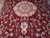 Cream central medallion and pendant detail surrounded by burgundy floral field with turquoise accents