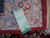 Inventory tag marked 5556 and 6.6 x 9.10 pinned to gold border edge
