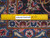 Back of the Kashan with ruler and Authentic Handmade label showing a tight knot count