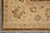 Corner view with ivory main border, dark brown outer band and natural white cotton fringe