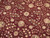 Macro detail of silk highlighted rosettes, lotus blossoms and delicate vinework across the red field