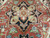 Center medallion close-up showing crisp knotting, ivory cartouche and rust ground of the Serapi design