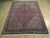 6'6" x 8'8" Bijar Persian wool rug shown at an angle across pale hardwood flooring