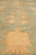 Angled pile view showing apricot vase motif and dense hand-spun natural wool texture