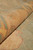 Rolled edge close-up showing plush wool pile depth and soft apricot border tones