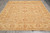 Sage and camel Ziegler Chobi wool rug displayed flat on grey tile showroom floor