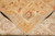 Folded corner revealing tight hand-knotted back and even weave of this natural wool rug