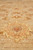 Field close-up of golden palmette motif with red center and soft brown outlines