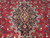 Detail of the navy central medallion with red rosette, ivory vines and turquoise floral sprays