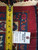 Back of rug with tape measure and dealer tag showing tight hand-knotted weave and fringe